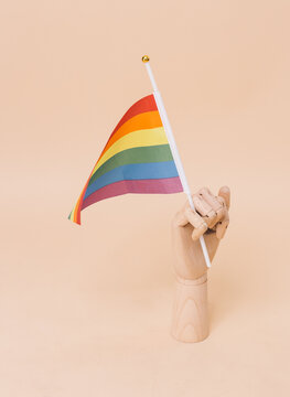 Hand waving rainbow flag