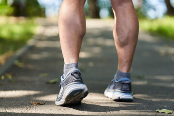 Fototapeta na wymiar Muscular calves and shoes of a runner