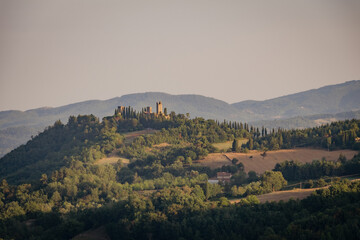 Fototapeta na wymiar ruins of an ancient medieval castle at sunset in the Tuscan hills