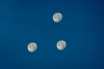 Three moons in the sky. Reflection of the moon.