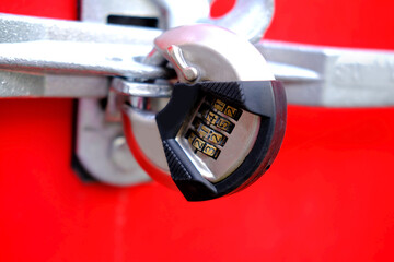 modern metal combination lock on a red container, the concept of secrecy, storage of wealth