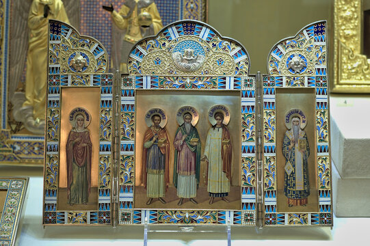 Saint Petersburg, Russia: February 20, 2019: Faberge Museum - Russian triptych icon Sts. Simon, Gury, & Aviv flanked by St. Antonina and St. Alexius. 1882 I. Khlebnikov.