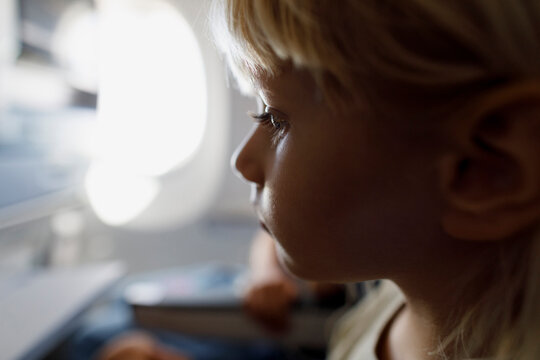 A little girl watching video in an airplane 