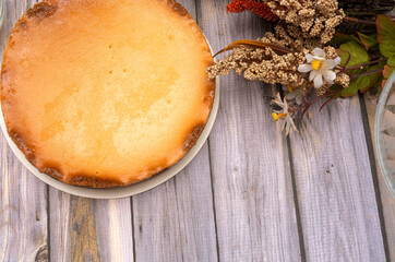 Homemade cheese pie on wooden table.