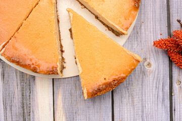 Homemade cheese pie on wooden table.