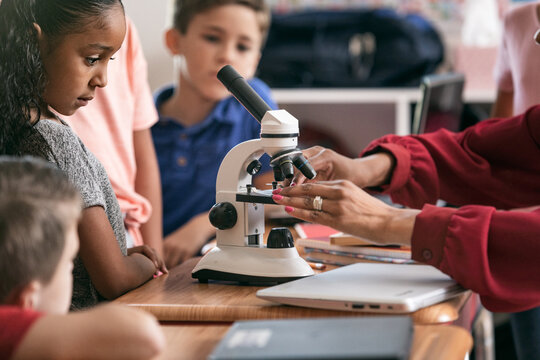 School: Students Gather To Learn Science With Microscope
