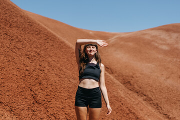 Girl Blocking Sun From Face in Desert