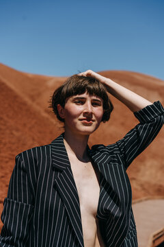 Woman Wearing Blazer and Nude Underneath In Desert Staring into Camera