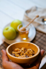 Eat the day with a healthy breakfast of honey muesli and apples