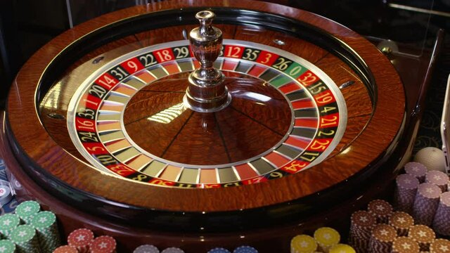 Close up shot of Casino roulette in motion . Spinning wheel ball . Gambling and casino concept with playing chips . Shot on RED EPIC DRAGON Cinema Camera in slow motion with camera move