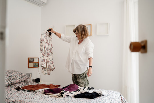 Cool Senior friends trying on clothes at home