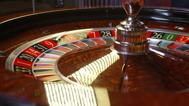 Close up shot of Casino roulette in motion . Spinning wheel ball . Gambling and casino concept with playing chips . Shot on RED EPIC DRAGON Cinema Camera in slow motion with camera move