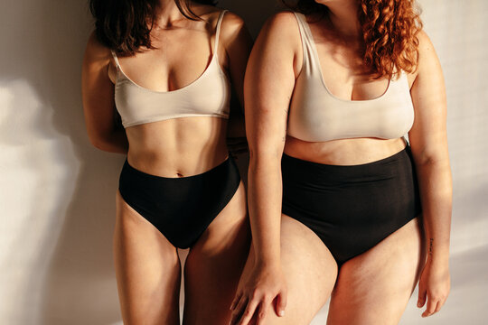 Cropped image of two women with different body type