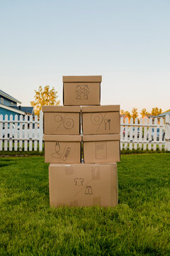 Carton boxes with icons in yard