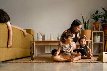 Pregnant mother relaxing with her children at home