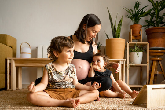 Pregnant mother having fun with her children at home