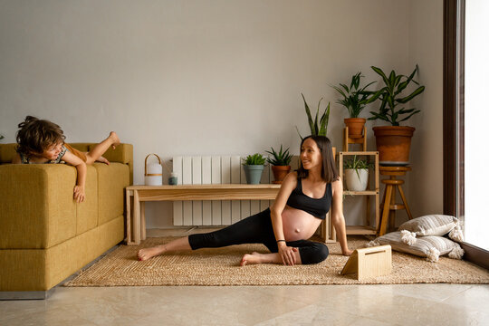 Pregnant woman doing meditation at home