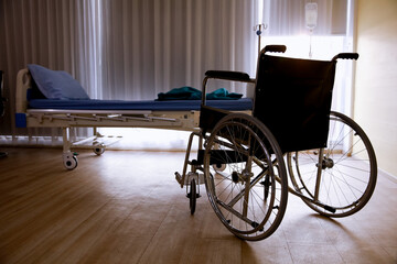 Fototapeta na wymiar Empty wheel chair and the Patient's bed in the hospital