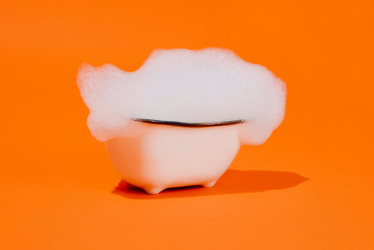 classic white bathtub full of soap foam