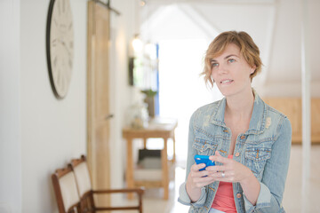 Portrait of woman using smartphone in office