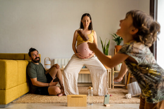 Pregnant woman performing a prepartum class at home 
