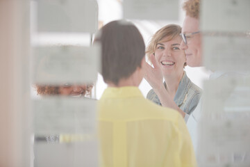 Women talking and smiling in office