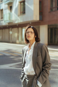 Tranquil stylish woman in suit in city