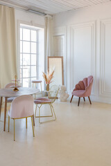 delicate and cozy light interior of the living room with modern stylish furniture of pastel pink...