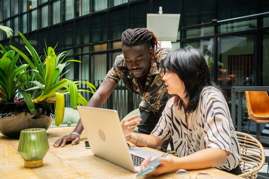A Couple Of Colleagues Sharing Ideas In A Modern Office