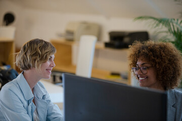 Women talking and smiling in office