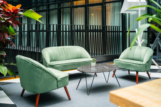 Green Couch And Two Armchairs In A Fancy Waiting Room.