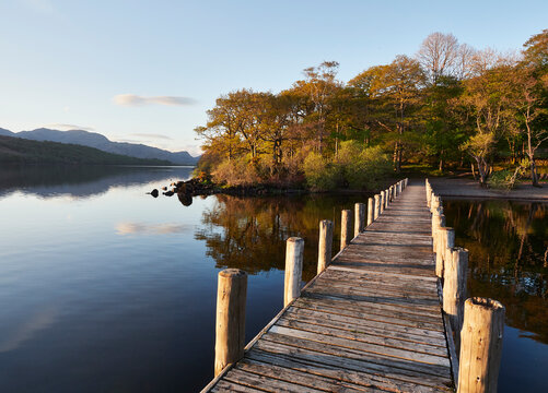 Sunset over jetty on Coniston water. Cumbria, UK.