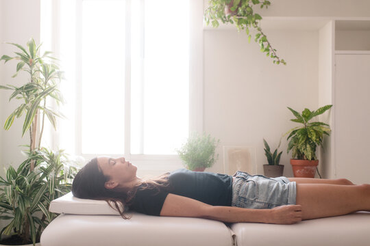 Meditating Lying Woman On Osteopath Consultation 