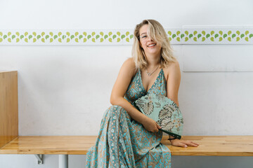 young blond woman use a fan