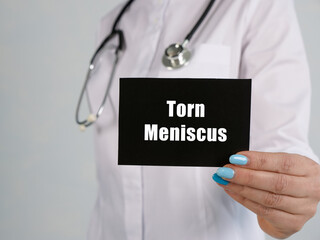 Healthcare concept meaning Torn Meniscus with sign on the piece of paper.