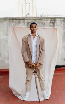 Portrait of stylish man in front of sheet background