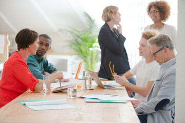 Office workers talking at desk