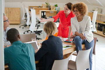 Office workers having meeting at desk