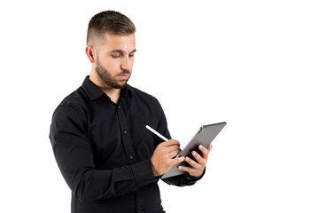 Young man with a black shirt taking notes on a grey tablet on a white background