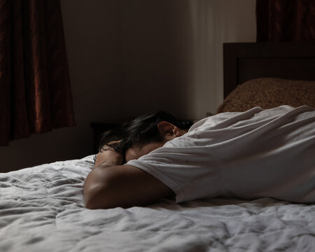Unrecognizable Man lying down on the bed.