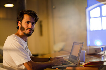 Casual businessman using laptop in office