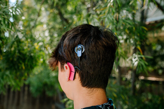 Back view of teen boy with Cochlear implants