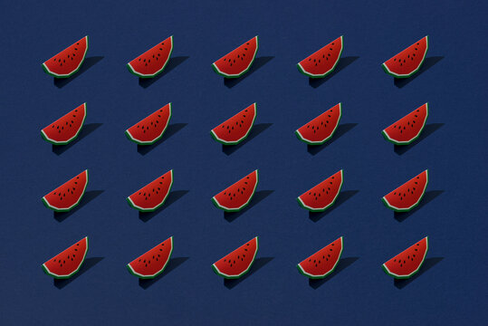 Creative summer food composition of sweet watermelon slices on blue background.