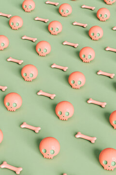 pattern of pink skulls and bone on green background
