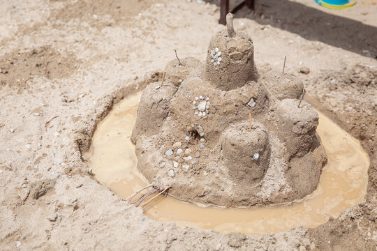 A sandcastle decorated with beautiful shells
