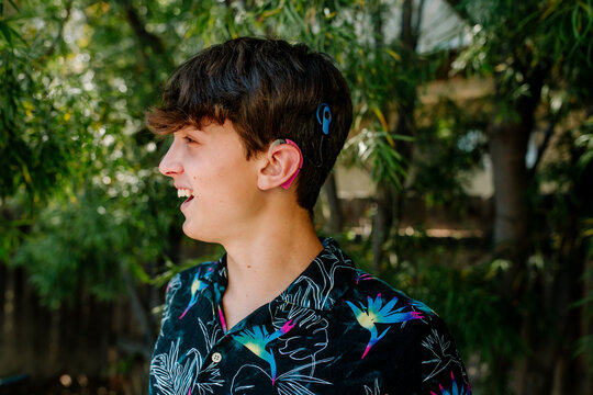 Smiling teen boy with hearing aids