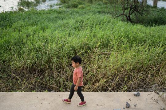 boy walking through the meadow