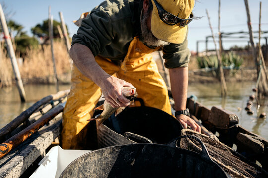 Fisherman holding a fish he has just caught