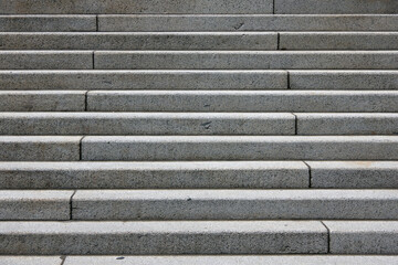 Full frame partial view of wide outside stairs made of concrete seen from the lower end