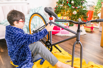 Boy assembling bicycle on Christmas day